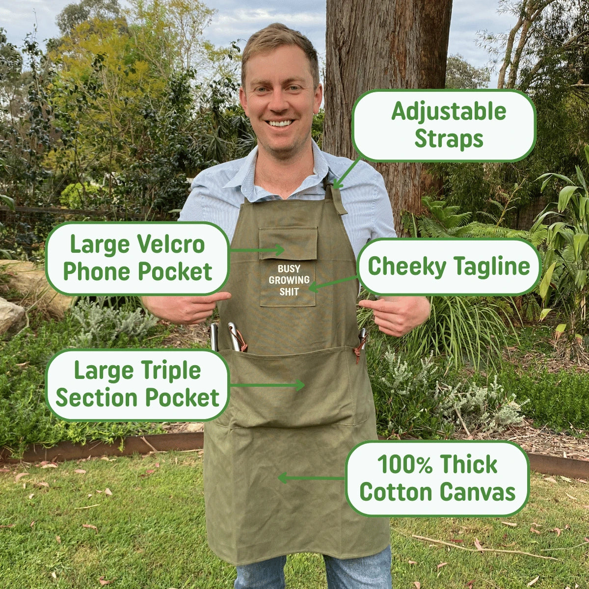 Man wearing a green apron with features highlighted in a garden setting