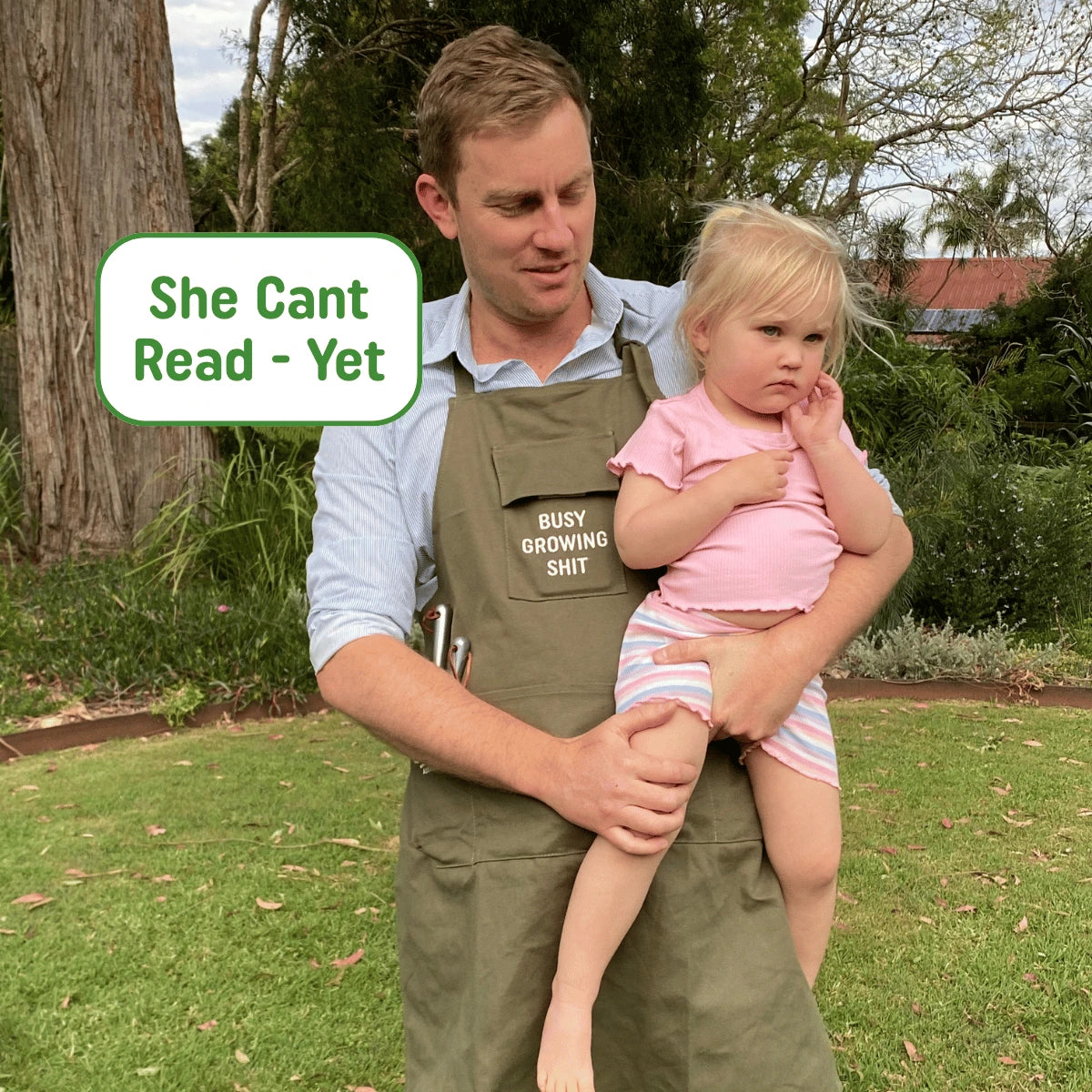 Man holding a child outdoors with text overlay