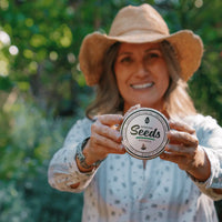 Woman holding Survival Starter Bundle seed packet.