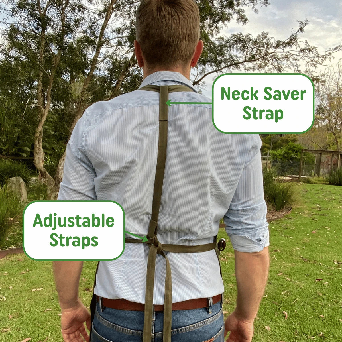Person wearing apron with labeled adjustable and neck saver straps in an outdoor setting.
